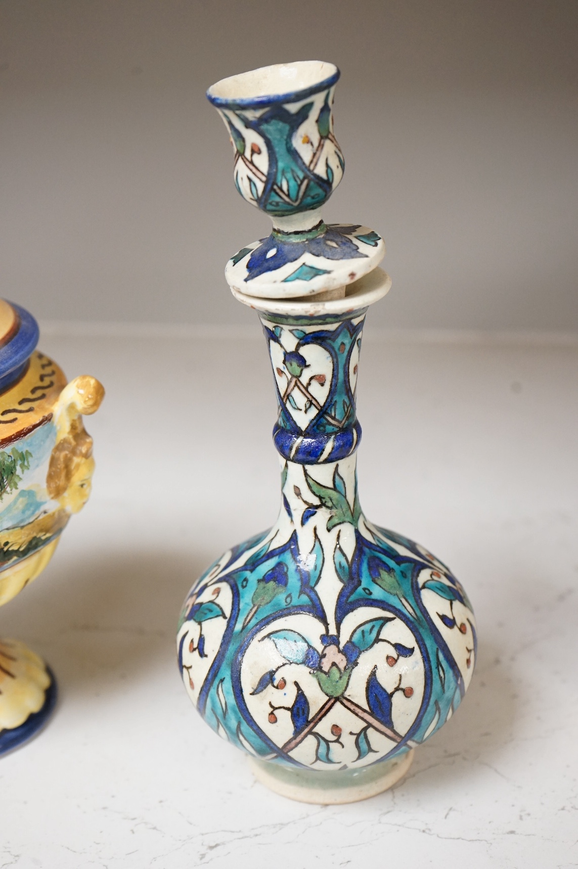 A pair of Isnik pottery vases and majolica vase and cover, largest 22cm high. Condition - fair, some restoration